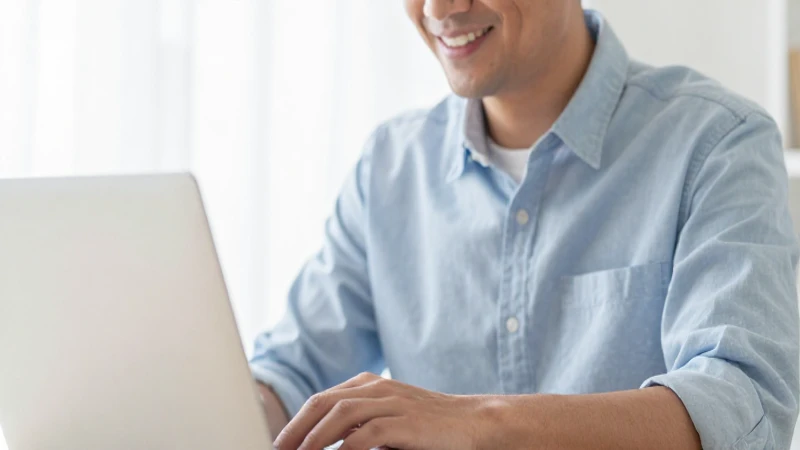 Adulto sonríe con su laptop a la luz